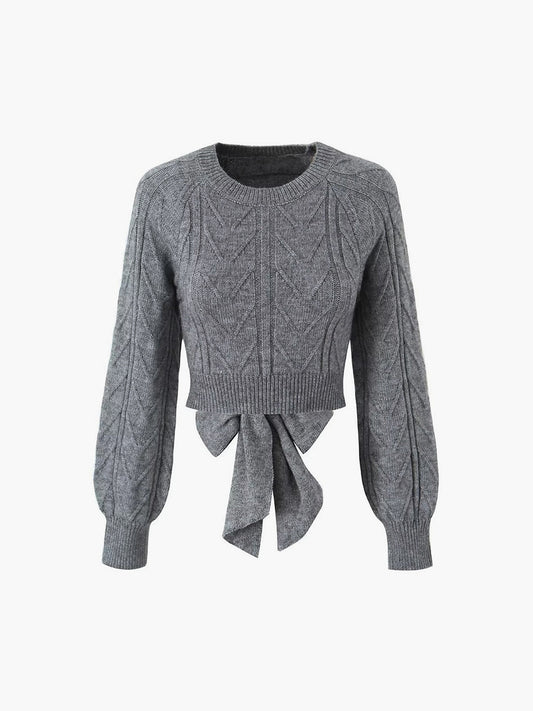 Pull court à dos noué en tricot câblé